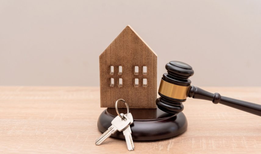 Wooden House Model with Gavel and House Keys on Table,Estate law and Legal property Processes